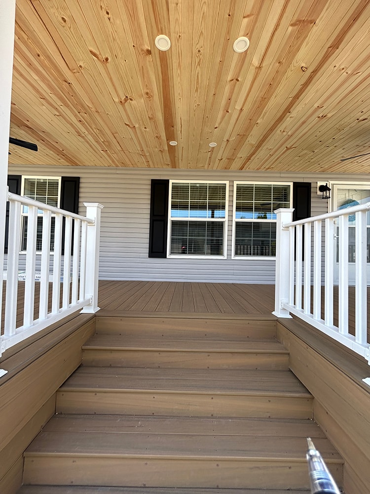 New composite deck with roof — cedar ceiling closeup with recessed lights looking toward stairs — Findlay, Ohio