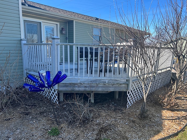 New composite deck — before: original white wood deck side view with lattice skirting — Findlay, Ohio