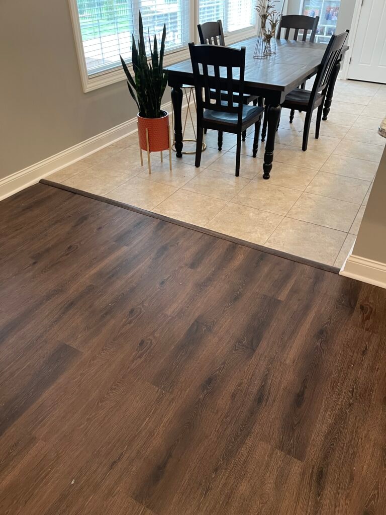 New LVP flooring — transition between new dark LVP and existing tile at dining room entry, Findlay, Ohio