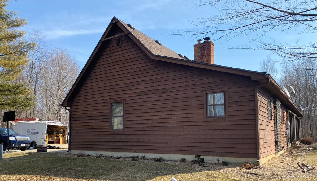 New siding Findlay — before: garage end gable of home with original brown cedar siding and brick chimney, Findlay, Ohio