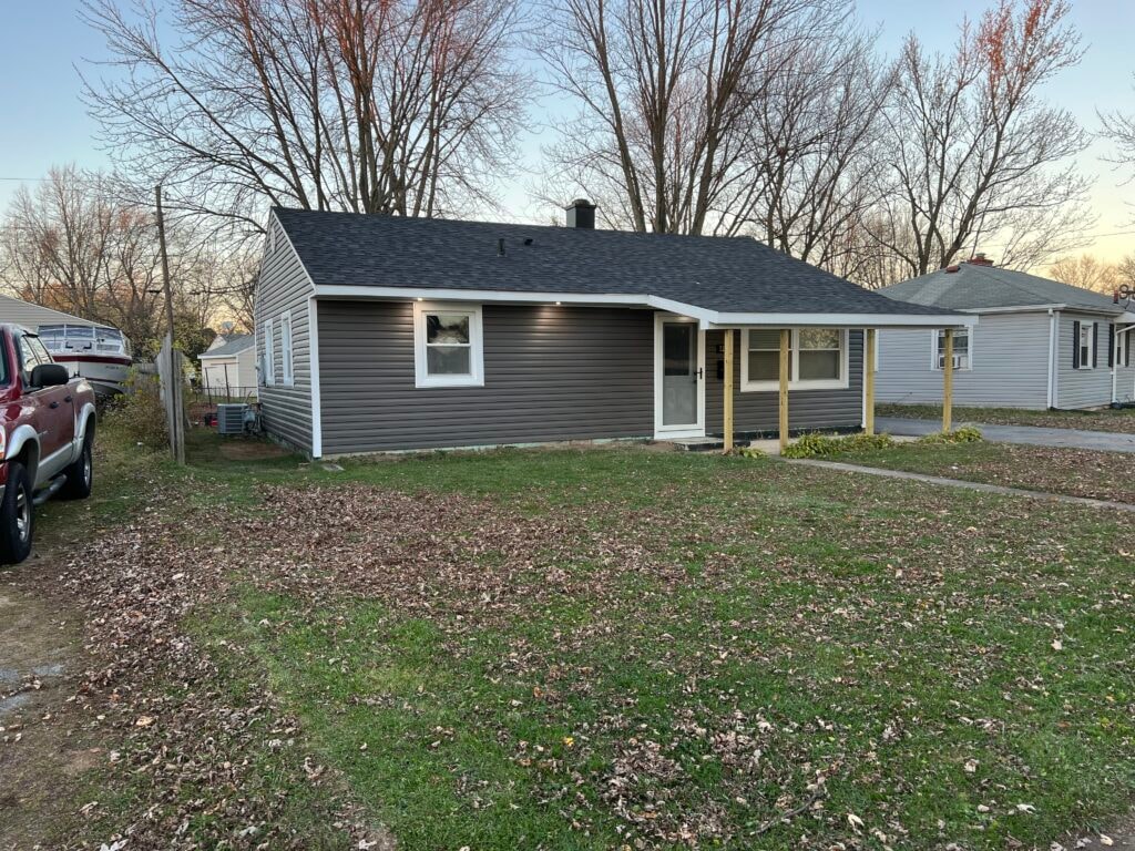 New vinyl siding — house front completed view from street with new gray siding, Fostoria, Ohio