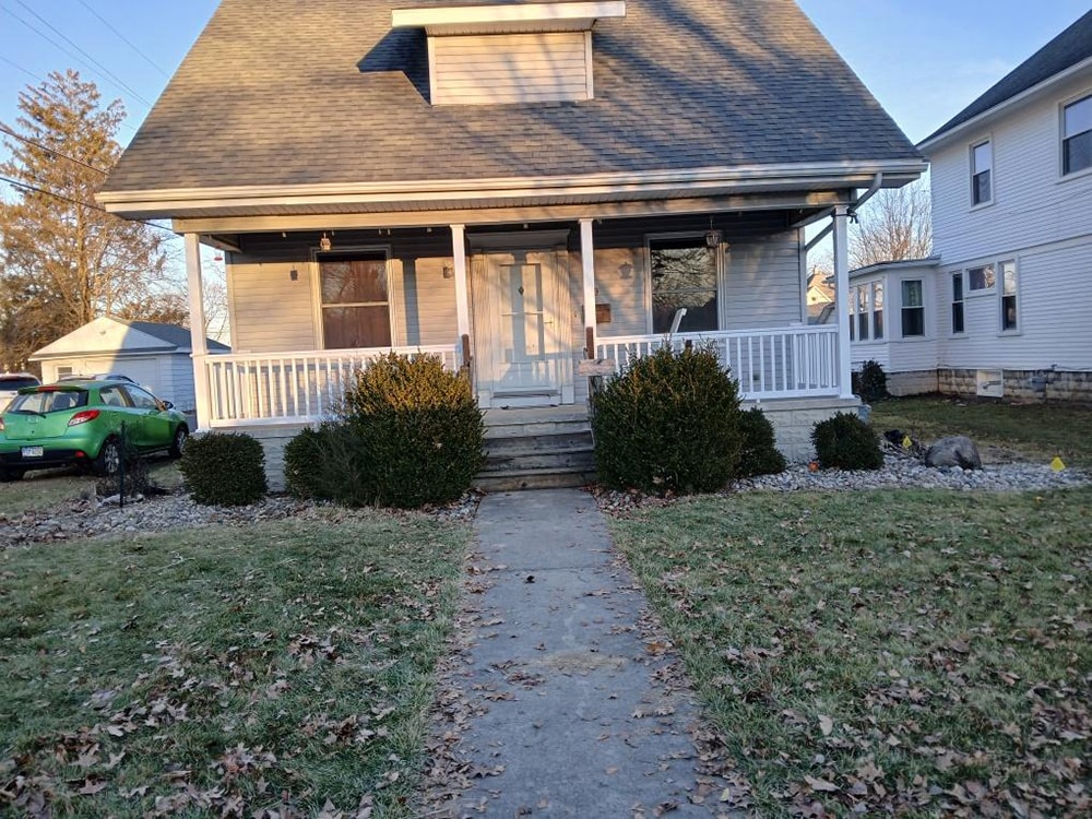 Porch railing replacement — after: full front view with new white railing in late fall — Findlay, Ohio