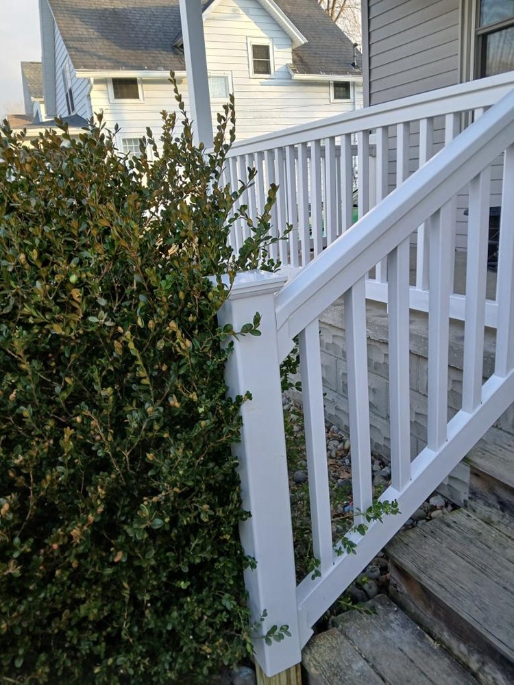 Porch railing replacement — after: closeup of new white stair railing and post — Findlay, Ohio