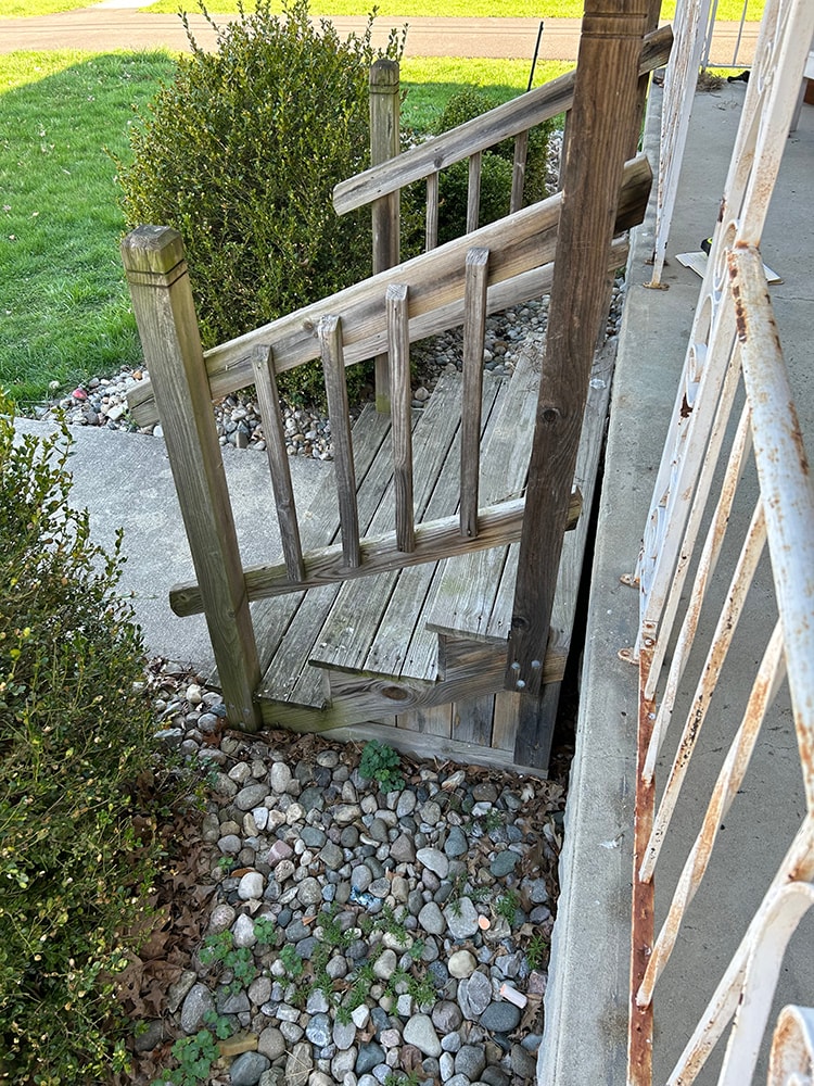 Porch railing replacement — before: closeup of old rotted wood gate and rusted iron railing — Findlay, Ohio