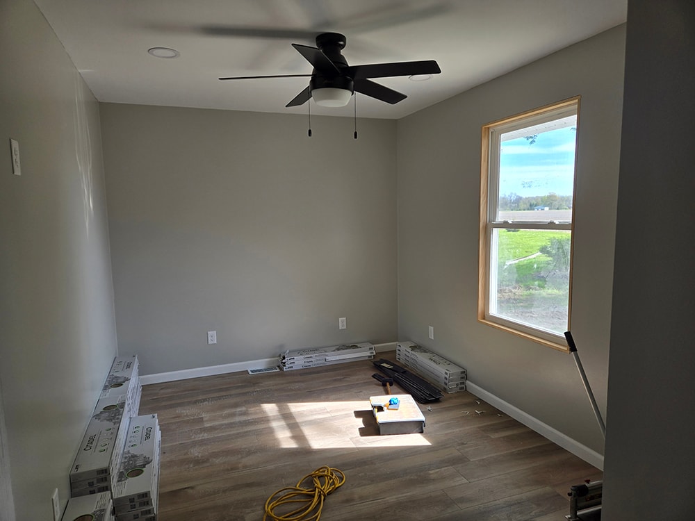 Home addition — interior near completion with new flooring, drywall, and ceiling fan — Findlay, Ohio