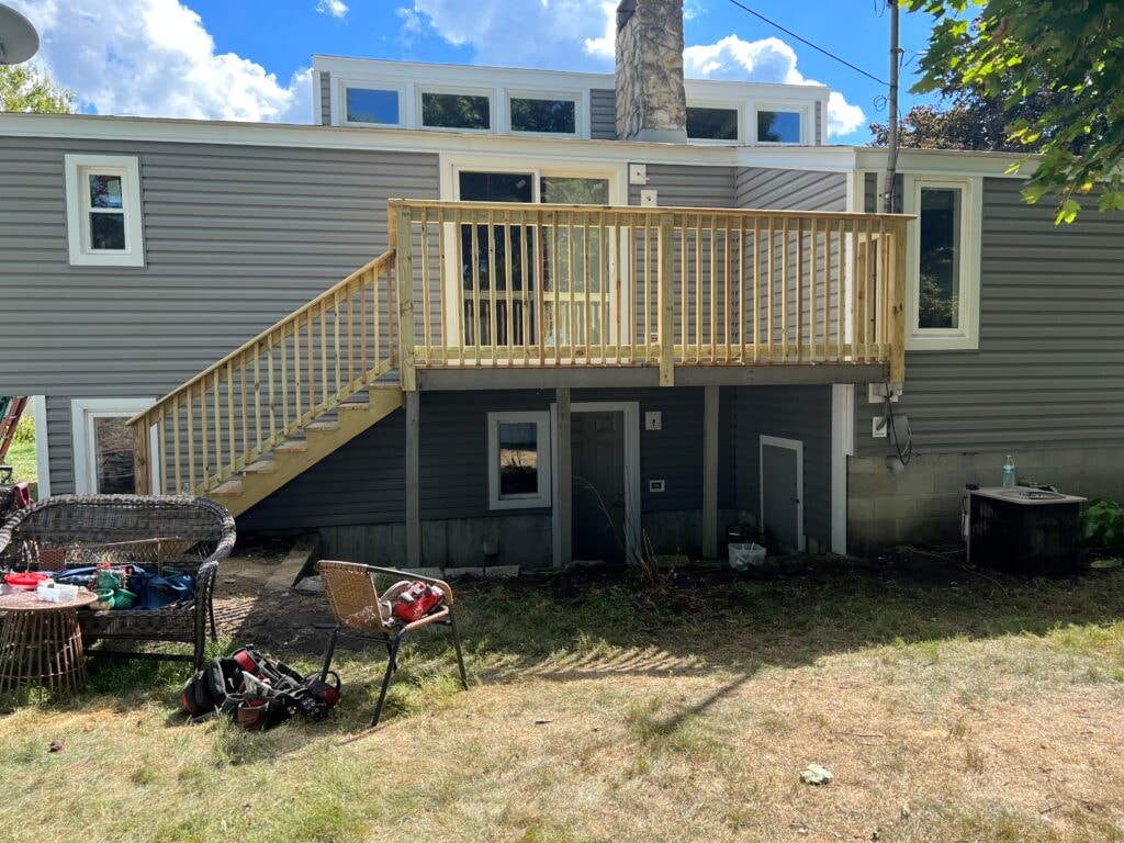 Siding, deck, flooring and stairs — rear deck after, new treated lumber deck with fresh railing and new siding, Findlay, Ohio