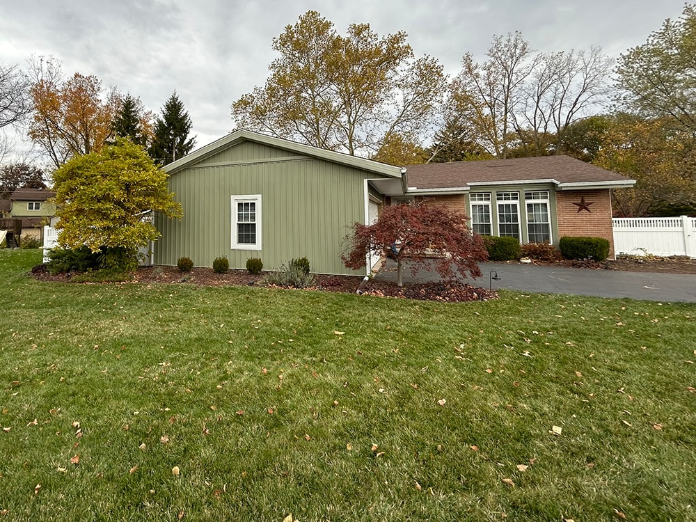 New board and batten siding — front of home with landscaping in Findlay, Ohio