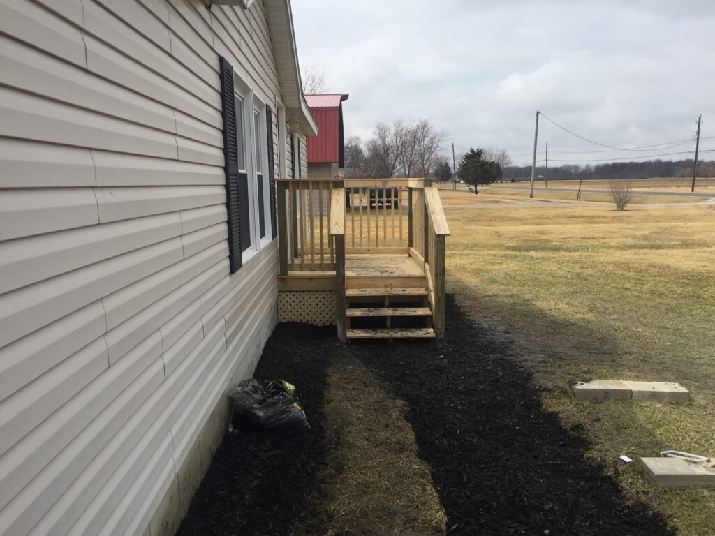 Simple front porch addition Oak Harbor — after: side view of completed deck with lattice skirting, Oak Harbor, Ohio