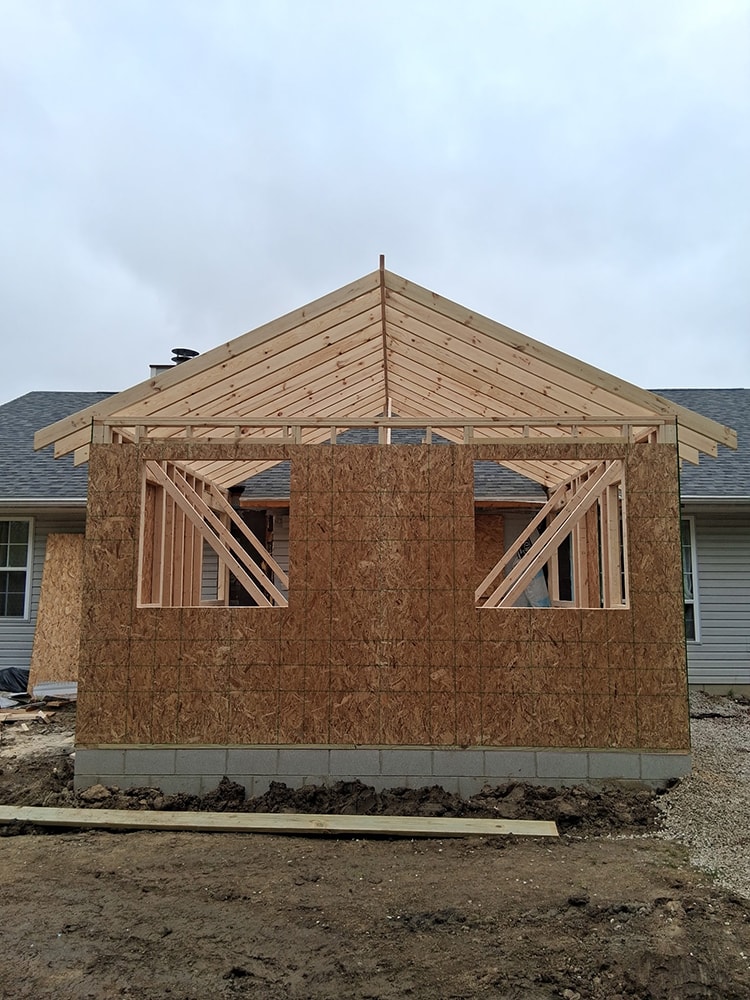 Small home addition — framing stage rear view with roof trusses — Findlay, Ohio