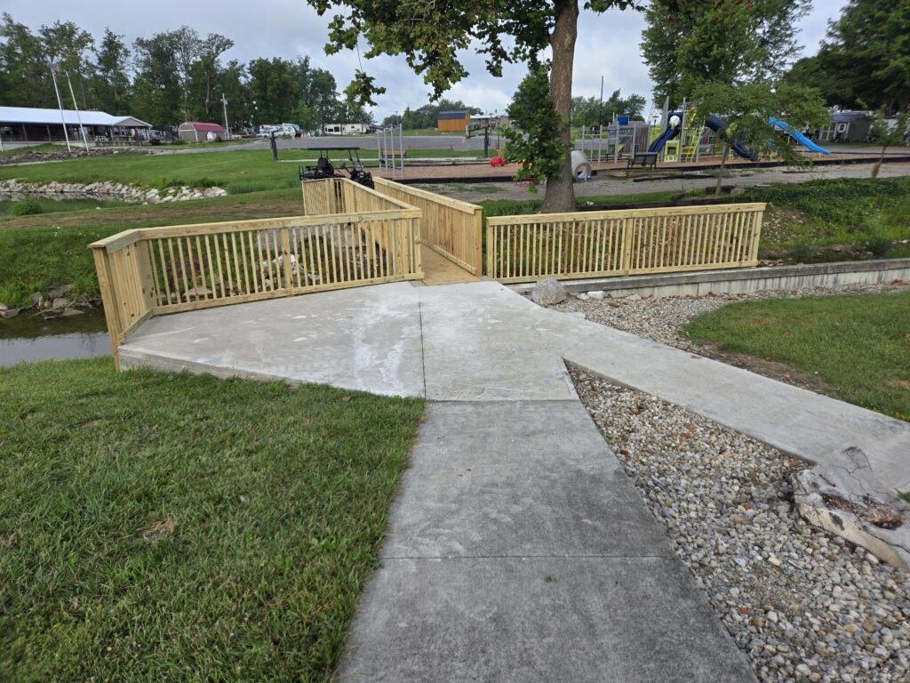 Steel and treated wood bridges — bridge 2 completed front view with wood railings and concrete pad — Findlay, Ohio